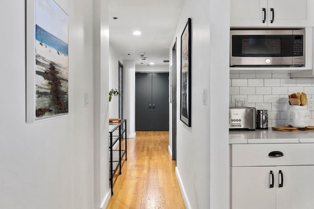 121-123 Beach St Unit 603, Boston, MA 02111 - hallway featuring light wood-type flooring, baseboards, and recessed lighting