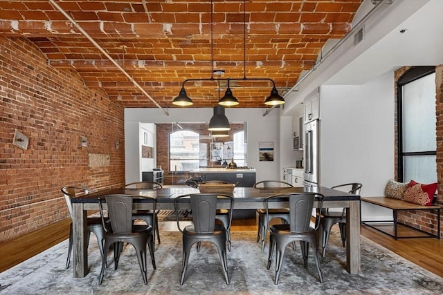 121-123 Beach St Unit 603, Boston, MA 02111 - dining area with brick wall, brick ceiling, and wood finished floors