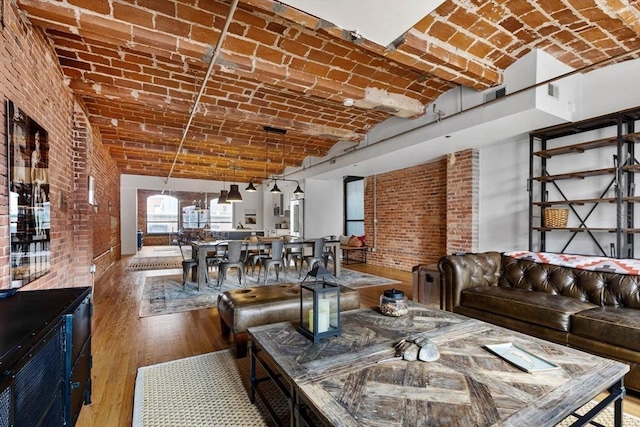 121-123 Beach St Unit 603, Boston, MA 02111 - living area featuring brick ceiling, wood finished floors, and brick wall