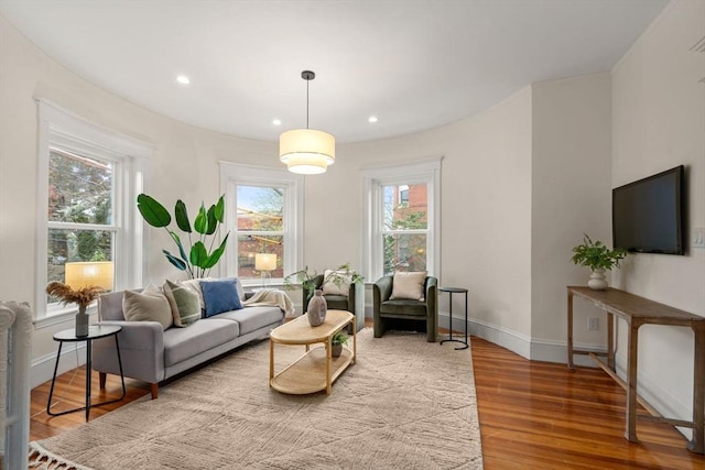 living room featuring wood finished floors, recessed lighting, and baseboards