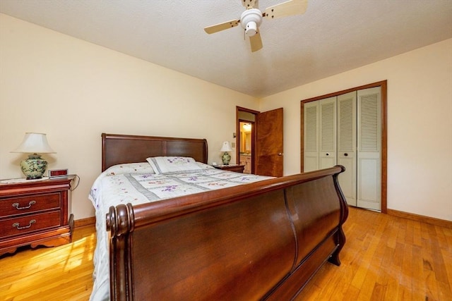 bedroom featuring light wood-type flooring, a closet, and ceiling fan