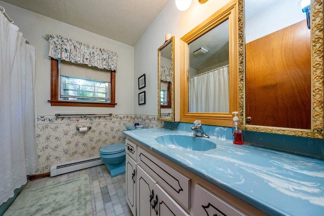 bathroom featuring a baseboard radiator, tile patterned flooring, a textured ceiling, vanity, and tile walls