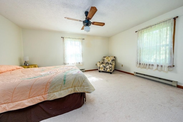 bedroom featuring ceiling fan, carpet floors, a textured ceiling, and a baseboard radiator