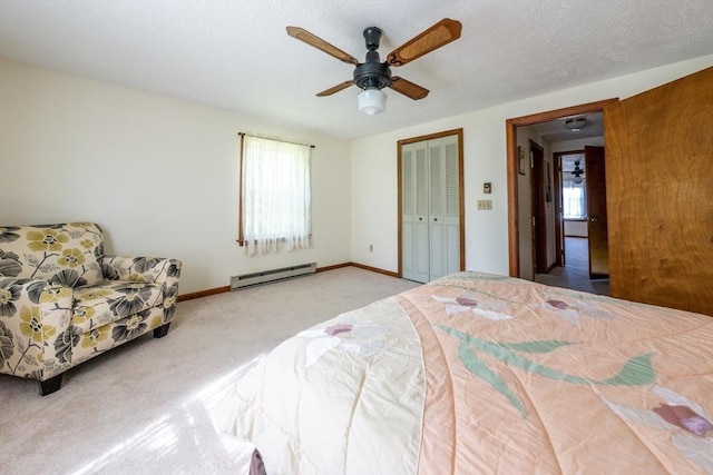 bedroom featuring ceiling fan, a baseboard radiator, light colored carpet, a textured ceiling, and a closet