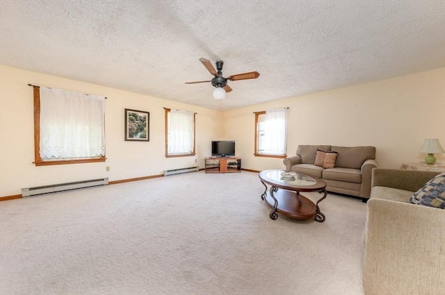 living room featuring ceiling fan, a textured ceiling, light carpet, and a baseboard heating unit