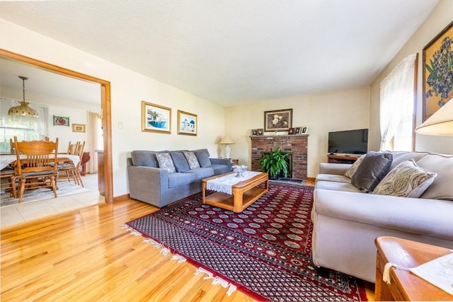 living room featuring hardwood / wood-style floors and a brick fireplace