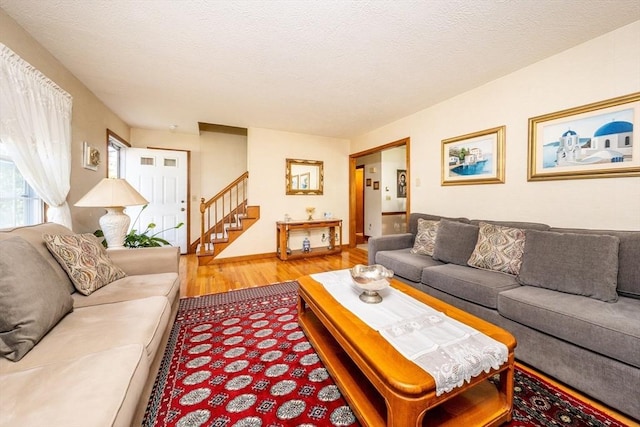 living room with hardwood / wood-style floors and a textured ceiling