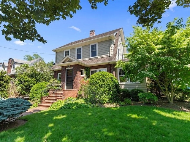 161 Playstead Rd, Medford, MA 02155 - view of front of home featuring a chimney, a front yard, and brick siding