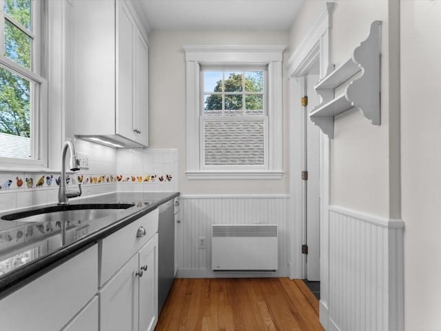161 Playstead Rd, Medford, MA 02155 - kitchen featuring wainscoting, white cabinetry, wood finished floors, and stainless steel dishwasher