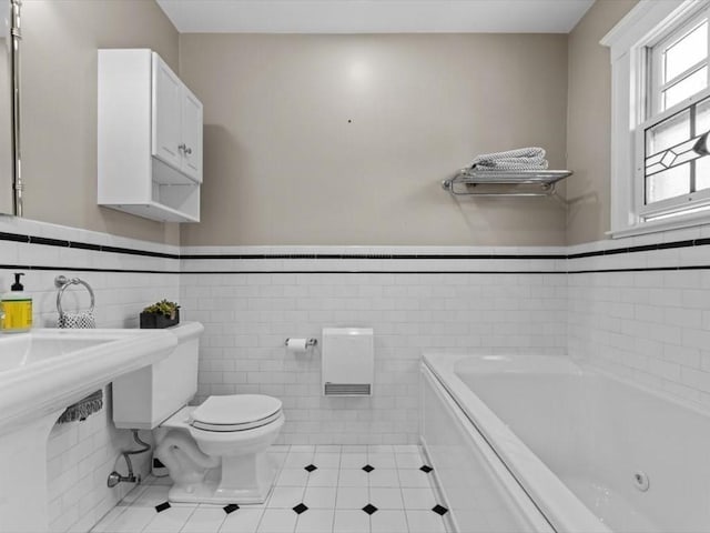 161 Playstead Rd, Medford, MA 02155 - full bath featuring a jetted tub, tile patterned flooring, wainscoting, and tile walls