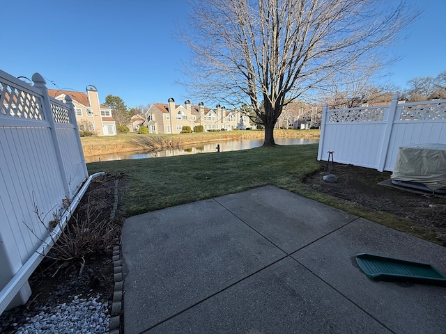 view of yard featuring a water view and a patio