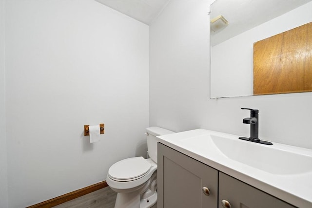 32-34 Lawn St, Attleboro, MA 02703 - half bath featuring vanity, toilet, wood finished floors, and baseboards