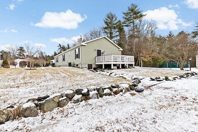 snow covered property featuring a wooden deck