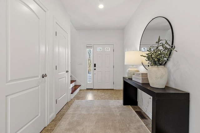 foyer entrance with light tile patterned flooring