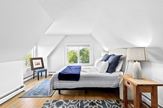 646 Jerusalem Rd Unit 7, Cohasset, MA 02025 - bedroom with a baseboard heating unit, vaulted ceiling, and hardwood / wood-style floors