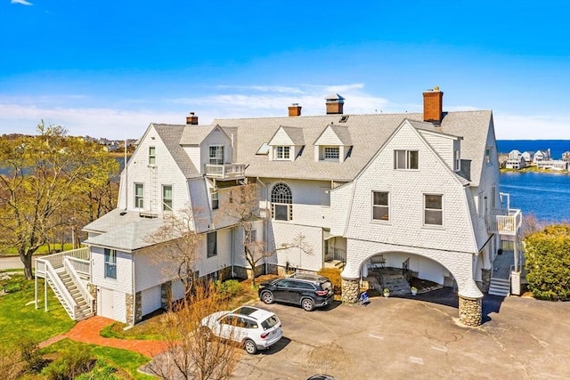 646 Jerusalem Rd Unit 7, Cohasset, MA 02025 - view of front of home featuring stairs, a water view, a balcony, and a shingled roof