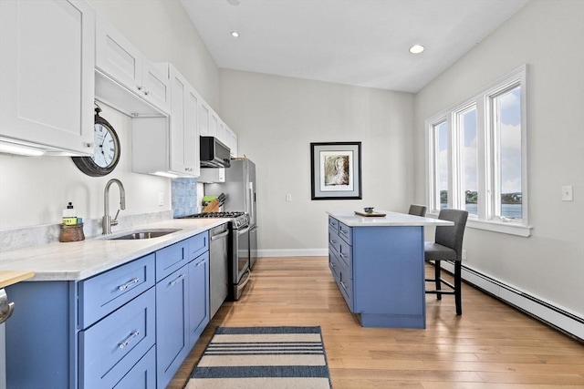 646 Jerusalem Rd Unit 7, Cohasset, MA 02025 - kitchen featuring a sink, blue cabinets, a baseboard radiator, light countertops, and recessed lighting