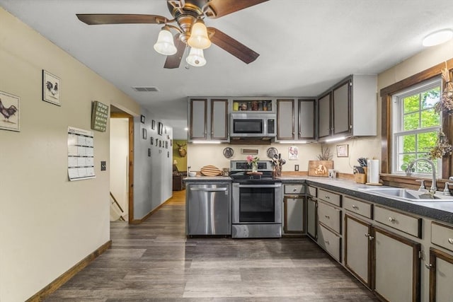255 State St, Belchertown, MA 01007 - kitchen with stainless steel appliances, dark wood-type flooring, dark countertops, and ceiling fan