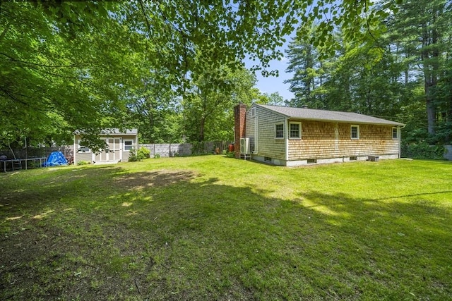 255 State St, Belchertown, MA 01007 - fenced backyard with a trampoline, a storage shed, and view of wooded area