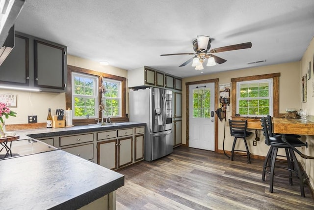 255 State St, Belchertown, MA 01007 - kitchen with stainless steel fridge with ice dispenser, healthy amount of natural light, wood finished floors, and ceiling fan