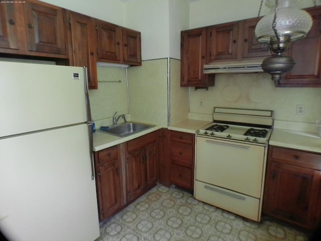 39 King St, Holyoke, MA 01040 - kitchen featuring white appliances, a sink, under cabinet range hood, and light countertops