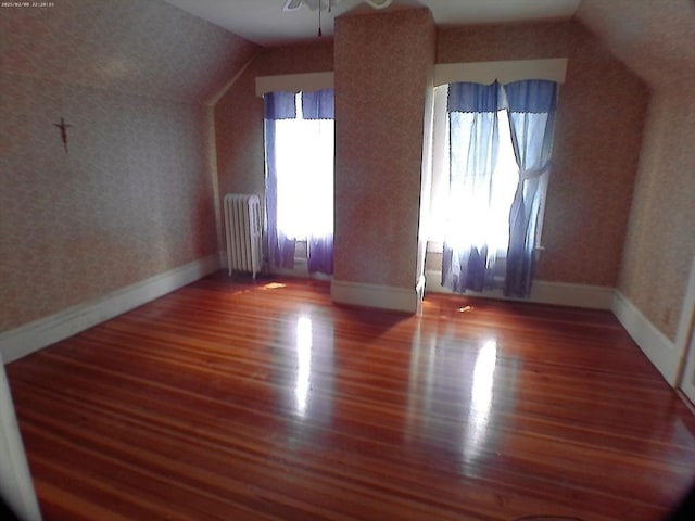 39 King St, Holyoke, MA 01040 - bonus room with radiator, wood finished floors, vaulted ceiling, baseboards, and wallpapered walls