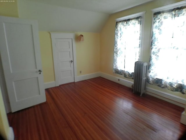 39 King St, Holyoke, MA 01040 - additional living space with radiator heating unit, vaulted ceiling, baseboards, and wood finished floors