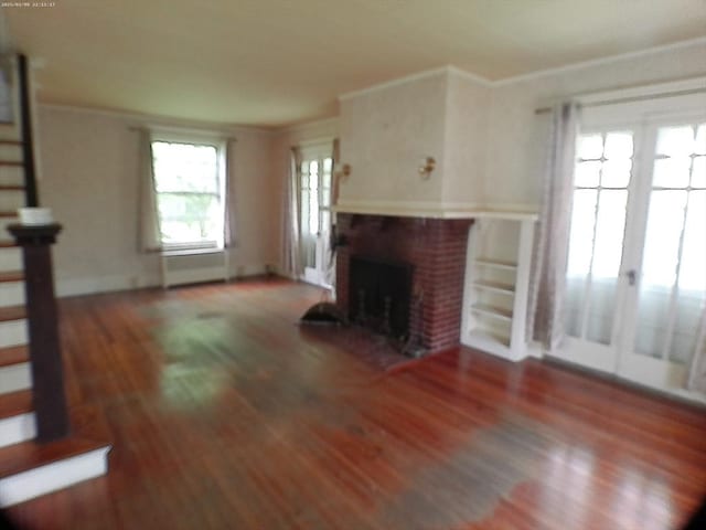 39 King St, Holyoke, MA 01040 - unfurnished living room with ornamental molding, wood finished floors, a fireplace, and stairway