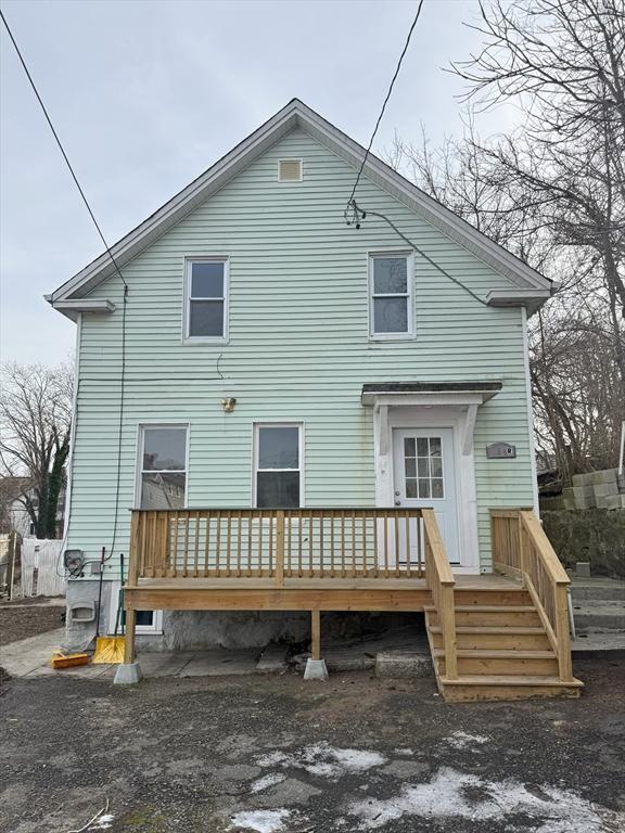 back of property featuring a wooden deck