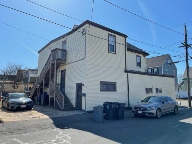 view of side of home featuring stairway