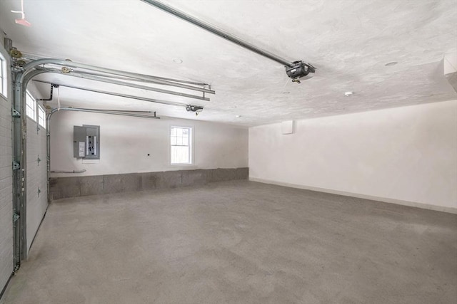 garage featuring electric panel, baseboards, and a garage door opener