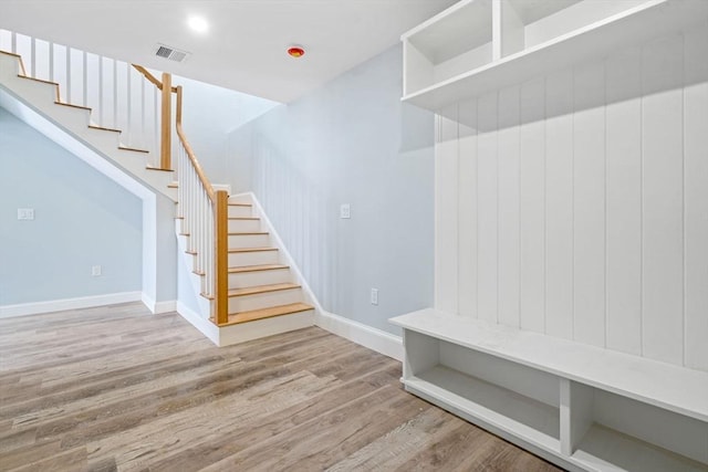 mudroom with visible vents, baseboards, and wood finished floors