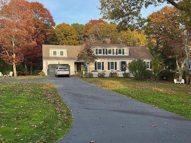 view of front of house with a front yard and a garage