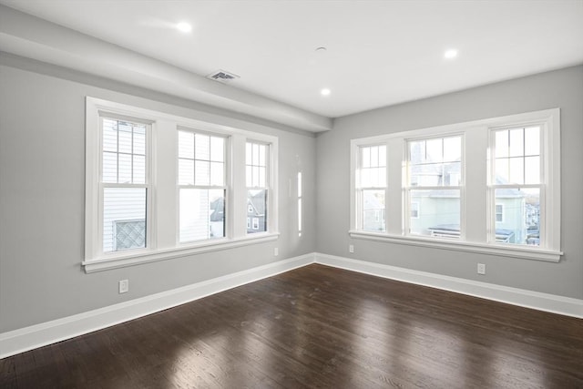 unfurnished room featuring recessed lighting, baseboards, visible vents, and dark wood-style floors