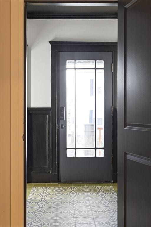 doorway to outside featuring light tile patterned flooring