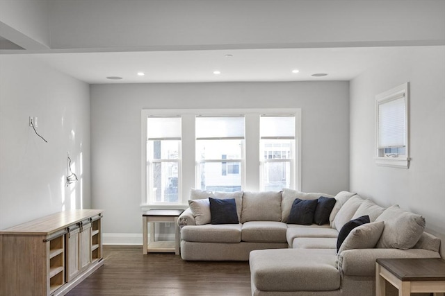 living room featuring recessed lighting, dark wood-style flooring, baseboards, and a wealth of natural light