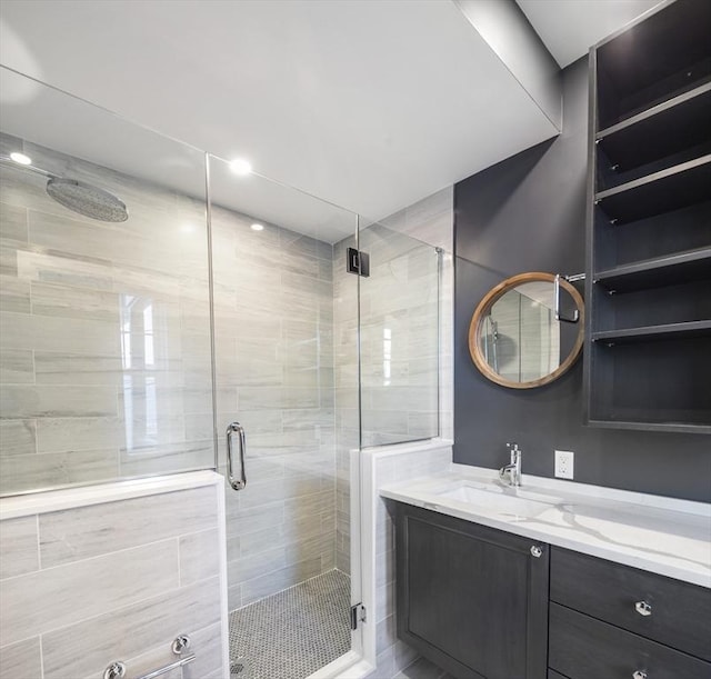 bathroom with a stall shower and vanity