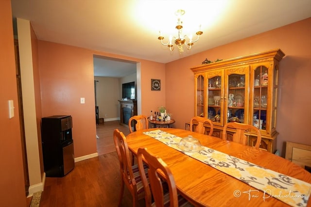 115 Arnold St, Fall River, MA 02724 - dining space with dark wood-type flooring, a chandelier, and baseboards