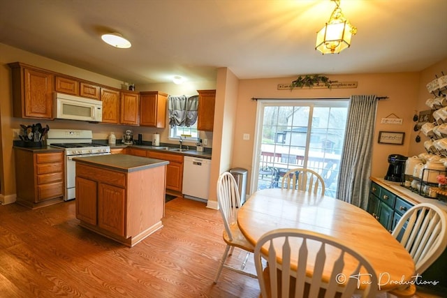 115 Arnold St, Fall River, MA 02724 - kitchen with dark countertops, white appliances, plenty of natural light, and a center island