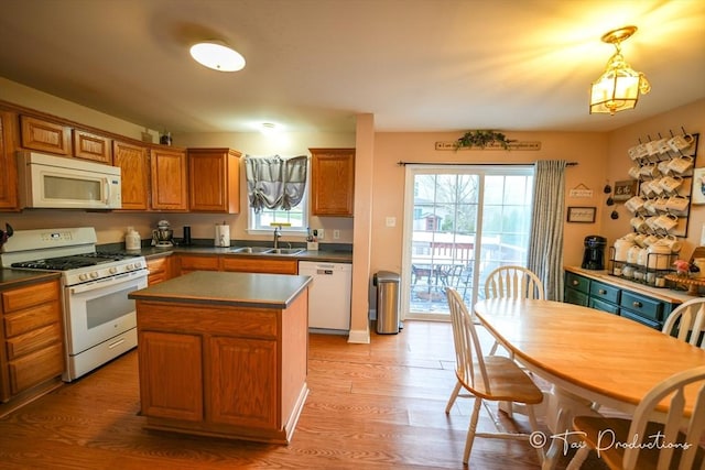 115 Arnold St, Fall River, MA 02724 - kitchen featuring dark countertops, white appliances, light wood finished floors, and a sink