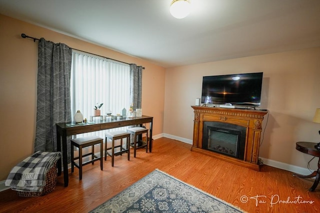 115 Arnold St, Fall River, MA 02724 - sitting room featuring a fireplace, wood finished floors, and baseboards