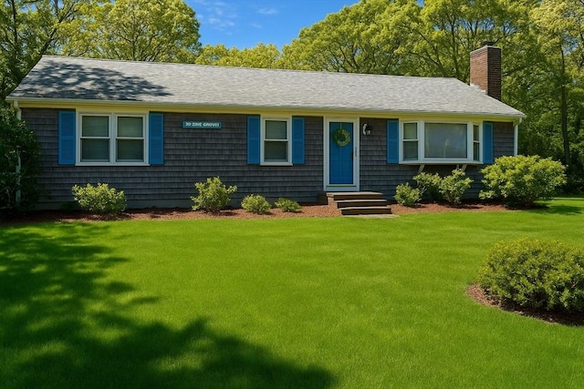 39 Pine Grove Rd, Yarmouth, MA 02664 - view of front facade featuring a chimney, a front yard, entry steps, and a shingled roof