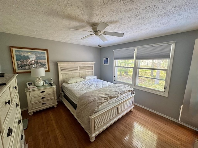 39 Pine Grove Rd, Yarmouth, MA 02664 - bedroom with dark wood-type flooring, baseboards, a textured ceiling, and ceiling fan