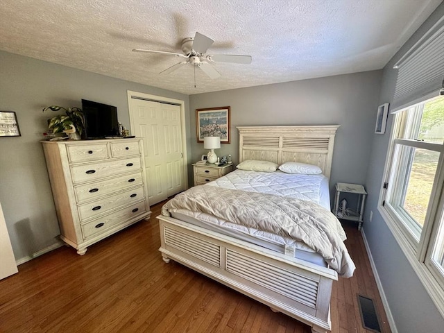 39 Pine Grove Rd, Yarmouth, MA 02664 - bedroom with dark wood-style floors, baseboards, a textured ceiling, and a ceiling fan