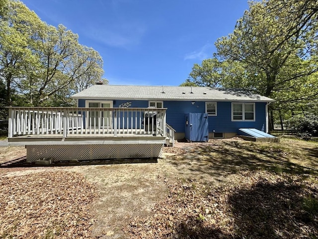 39 Pine Grove Rd, Yarmouth, MA 02664 - rear view of house with a deck and a chimney