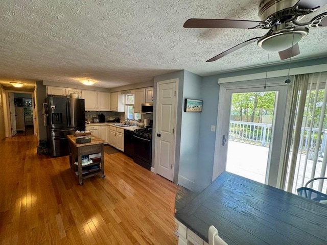 39 Pine Grove Rd, Yarmouth, MA 02664 - kitchen with black appliances, a ceiling fan, healthy amount of natural light, a textured ceiling, and wood finished floors