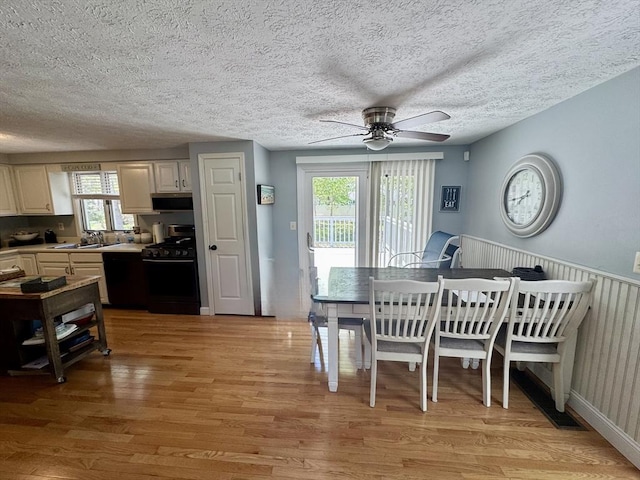 39 Pine Grove Rd, Yarmouth, MA 02664 - dining room with light wood-style flooring, a ceiling fan, and a textured ceiling