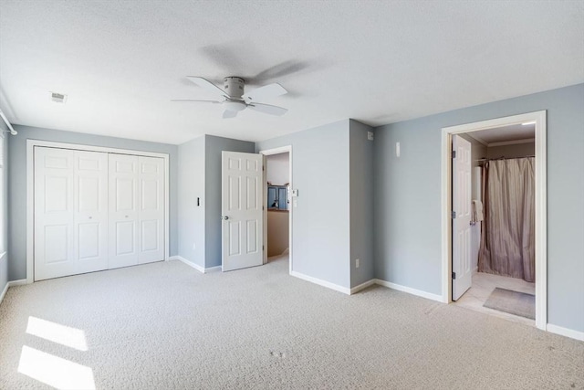 unfurnished bedroom featuring visible vents, carpet flooring, baseboards, and a closet