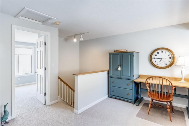 home office with baseboards, rail lighting, attic access, and light carpet