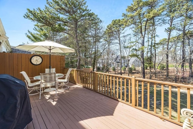 wooden deck featuring area for grilling and outdoor dining space